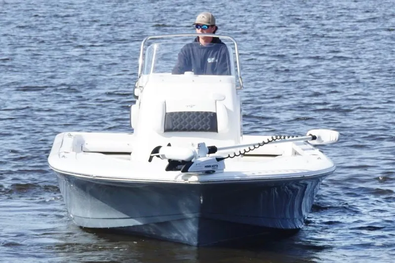Slide: The Image of 2022 Tidewater 2110 Bay Max boat on water with person steering. - 6