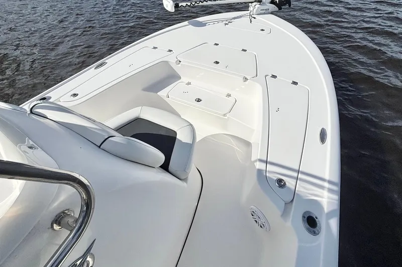 Slide: The Image of 2022 Tidewater 2110 Bay Max boat interior with seating and storage on water. - 9