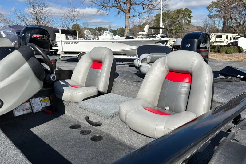 Slide: The Image of 2017 Tracker Pro Team 175 TXW boat interior with gray and red seats. - 10
