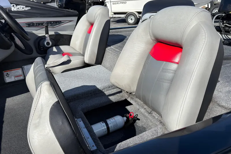 Slide: The Image of 2017 Tracker Pro Team 175 TXW boat interior with gray and red seats, fire extinguisher visible. - 11