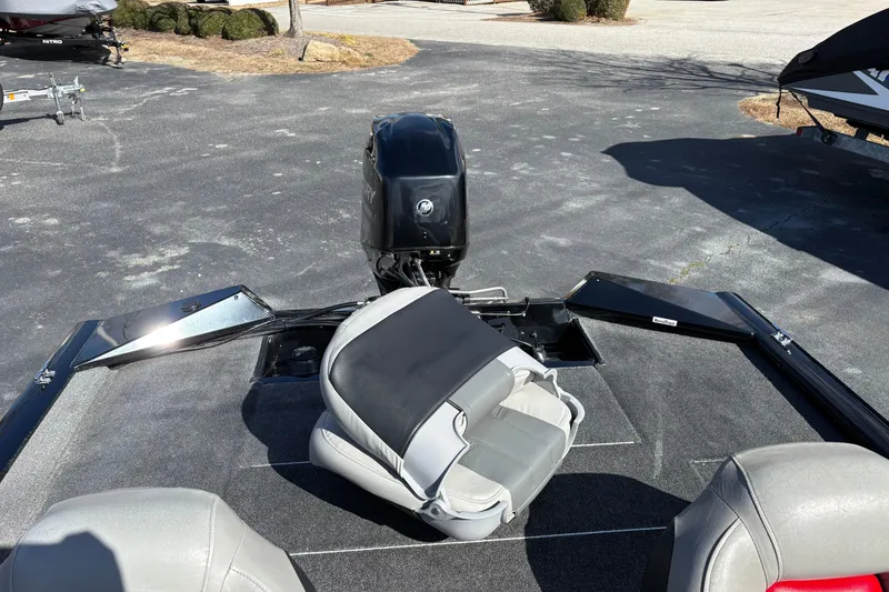 Slide: The Image of 2017 Tracker Pro Team 175 TXW boat with motor and seating, parked outdoors. - 12