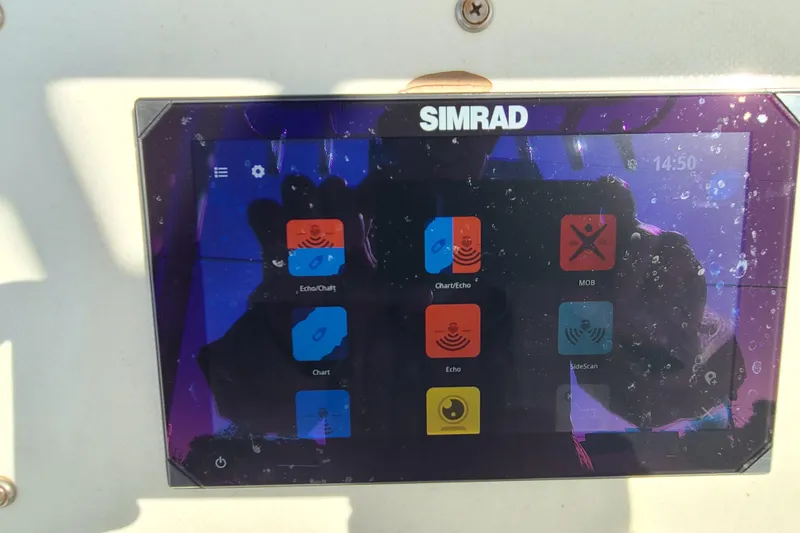 Slide: The Image of Simrad marine display on 1969 Aquasport 222 Center Console, showing navigation and sonar options. - 11