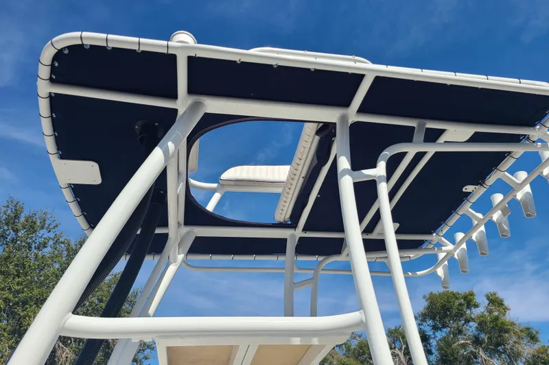 Slide: The Image of 1969 Aquasport 222 Center Console boat with T-top against blue sky. - 12