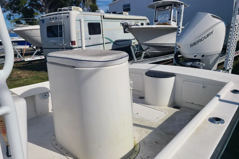 Slide: The Image of 1969 Aquasport 222 Center Console boat with Mercury engine, parked near RV and other boats. - 16