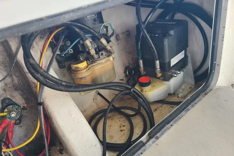 Slide: The Image of 1969 Aquasport 222 Center Console engine compartment with wiring and fluid reservoirs. - 26