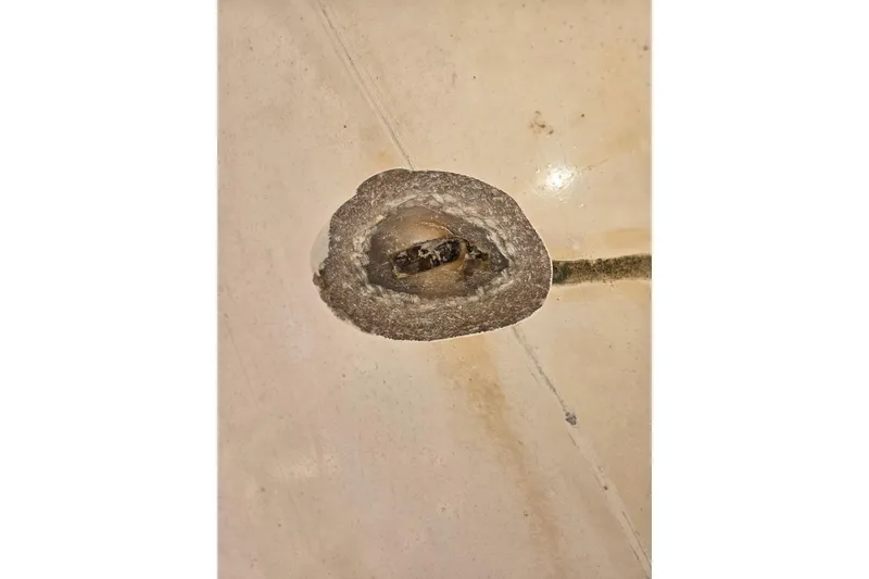 Slide: The Image of Corroded metal fitting on 1969 Aquasport 222 Center Console boat surface. - 30