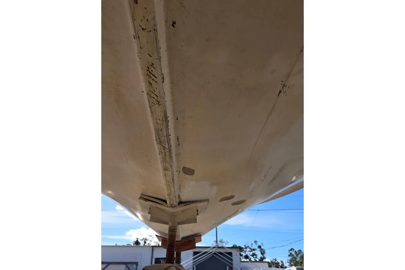 Slide: The Image of 1969 Aquasport 222 Center Console boat hull underside, showing wear and scratches. - 31