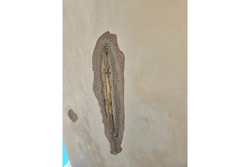 Slide: The Image of Damaged hull of 1969 Aquasport 222 Center Console boat showing exposed fiberglass. - 32