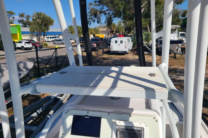 Slide: The Image of 1969 Aquasport 222 Center Console boat in a parking lot with surrounding vehicles. - 8