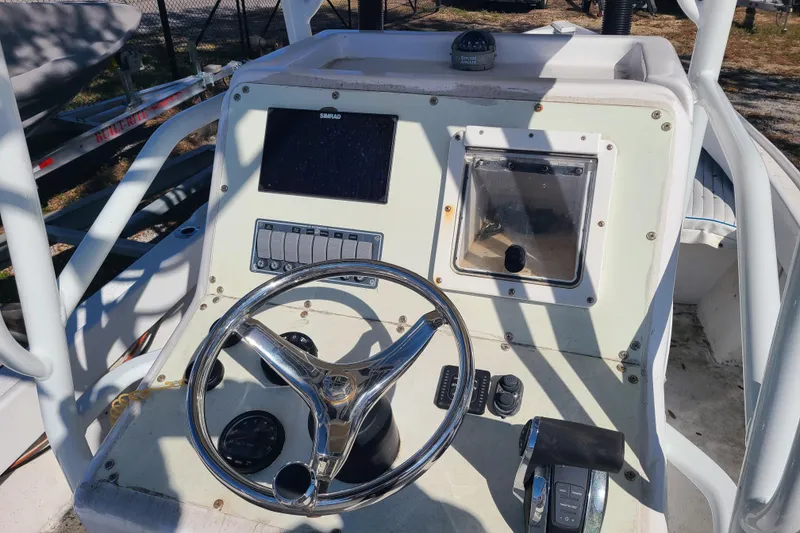 Slide: The Image of 1969 Aquasport 222 Center Console boat dashboard with steering wheel and controls. - 9
