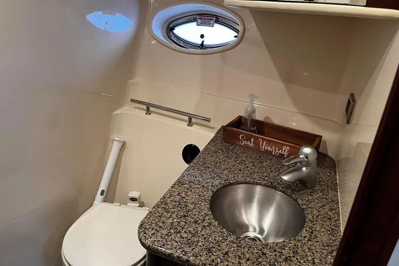 Slide: The Image of 2007 Sea Ray 38 Sundancer bathroom with granite countertop and stainless steel sink. - 12