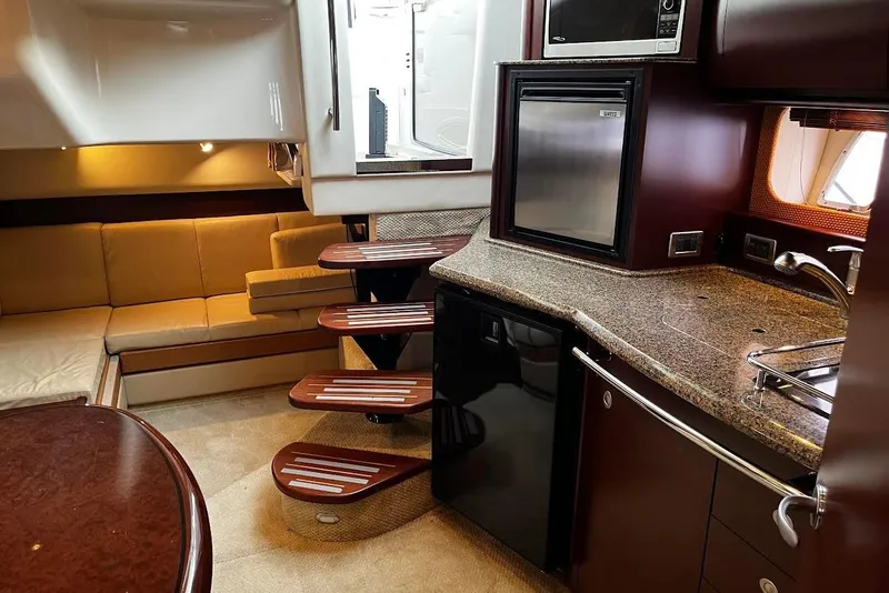 Slide: The Image of Interior of 2007 Sea Ray 38 Sundancer yacht with kitchen and seating area. - 14