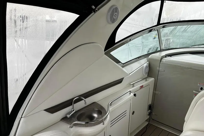 Slide: The Image of 2007 Sea Ray 38 Sundancer interior with sink and cabinetry, featuring sleek design and modern amenities. - 15