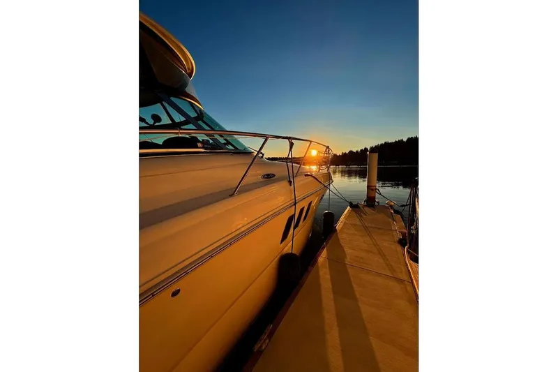 Slide: The Image of 2007 Sea Ray 38 Sundancer yacht docked at sunset, serene waterfront view. - 2