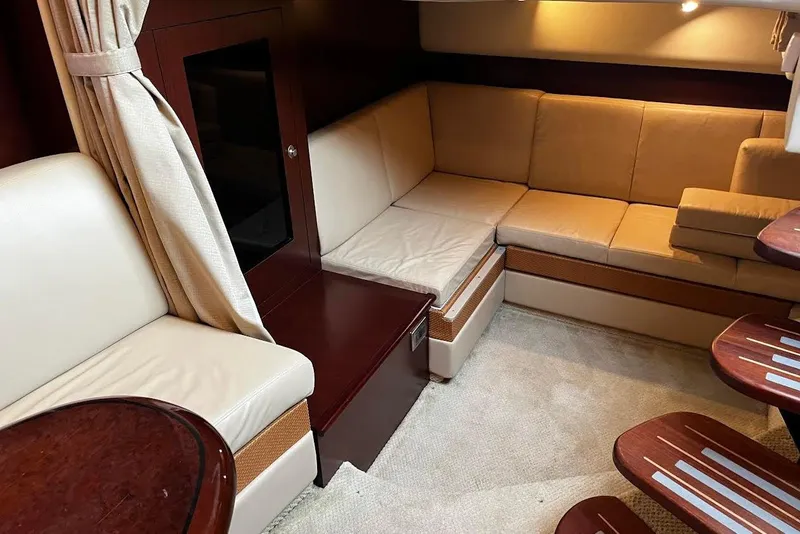 Slide: The Image of Luxurious interior of 2007 Sea Ray 38 Sundancer with beige seating and wooden accents. - 20