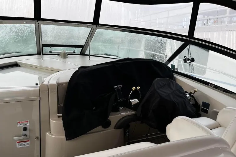 Slide: The Image of 2007 Sea Ray 38 Sundancer helm with covered controls and panoramic windows. - 4