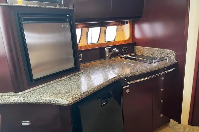Slide: The Image of Luxurious 2007 Sea Ray 38 Sundancer yacht kitchen with granite countertops and modern appliances. - 6