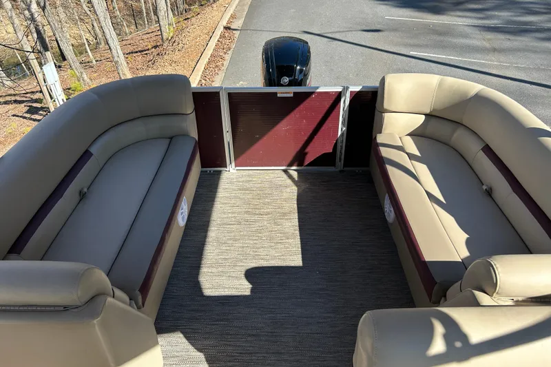 Slide: The Image of 2022 Godfrey Sweetwater 2286 C pontoon boat interior with beige seating and carpeted floor. - 11