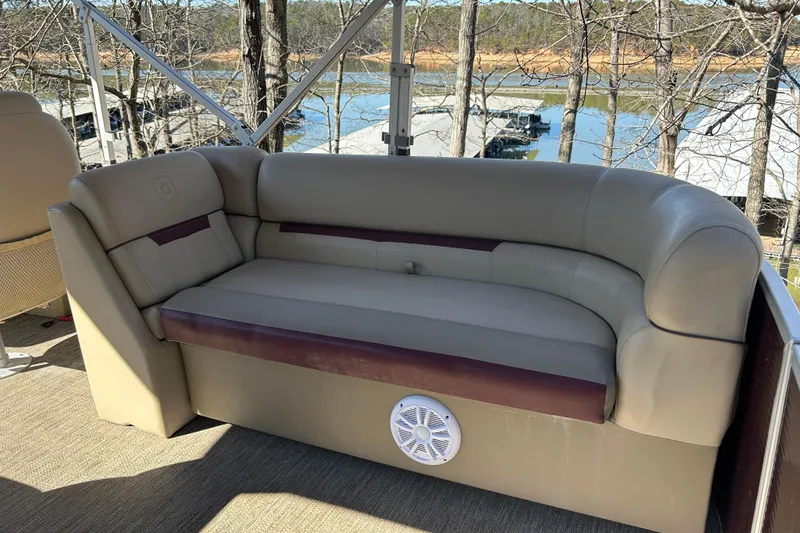 Slide: The Image of 2022 Godfrey Sweetwater 2286 C pontoon boat interior with comfortable seating and scenic lake view. - 14
