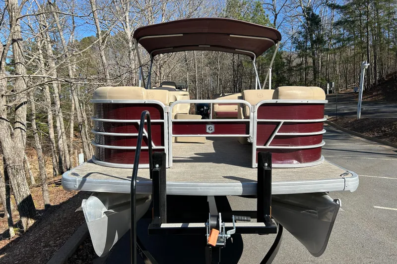 Slide: The Image of 2022 Godfrey Sweetwater 2286 C pontoon boat on trailer in wooded area. - 2