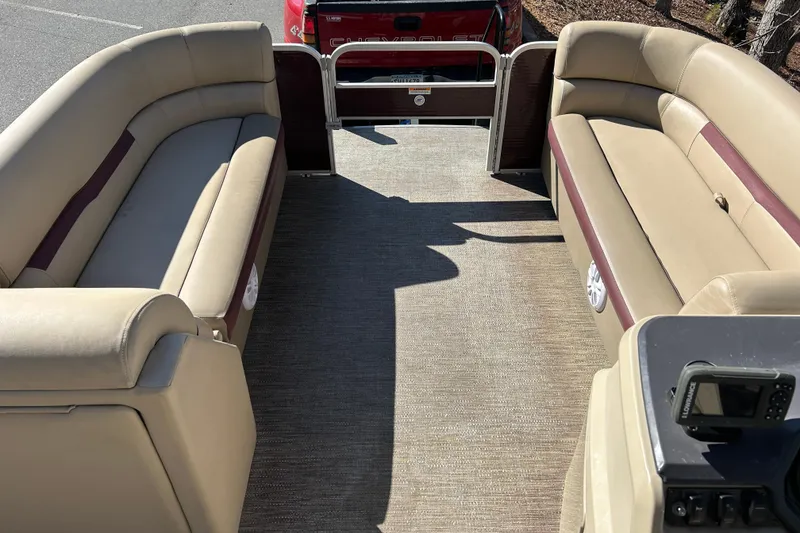 Slide: The Image of 2022 Godfrey Sweetwater 2286 C pontoon boat interior with beige seating and carpeted floor. - 9