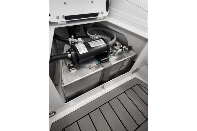 Slide: The Image of 2025 Highfield Sport 390 boat engine compartment with visible components and wiring. - 2