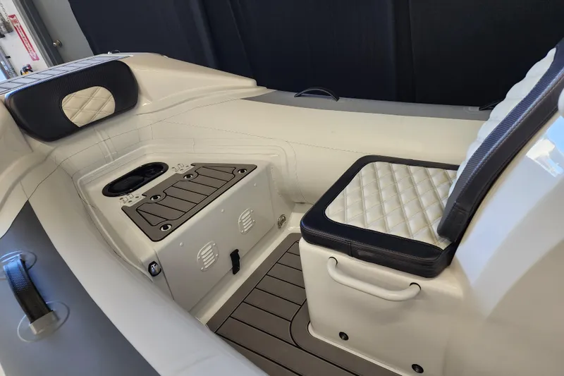 Slide: The Image of Interior of 2025 Highfield Sport 390 boat with cushioned seating and storage compartments. - 6