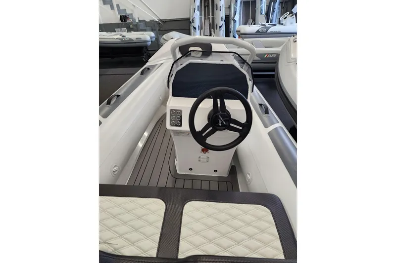 Slide: The Image of 2025 Highfield Sport 390 boat interior with steering wheel and seating. - 7
