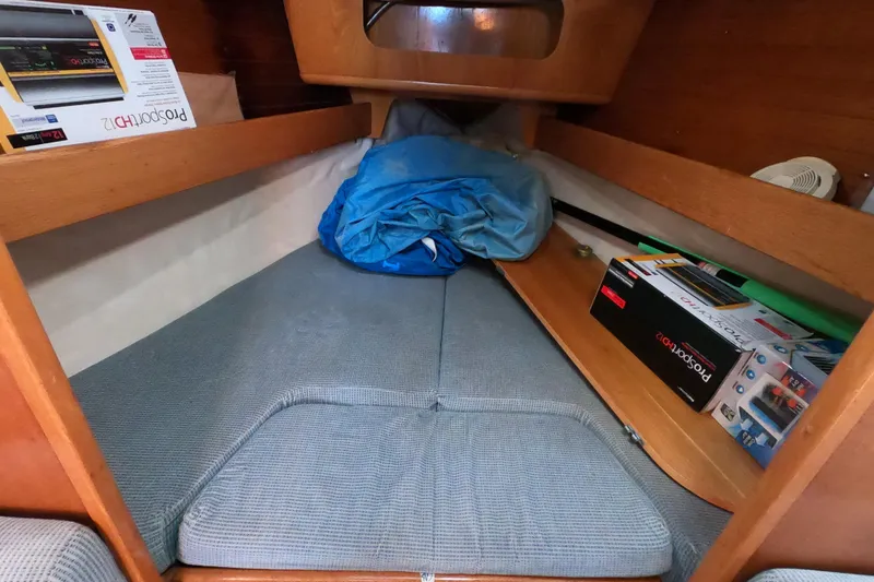 Slide: The Image of Cozy cabin interior of 1990 Beneteau First 285 sailboat with storage and bedding. - 14