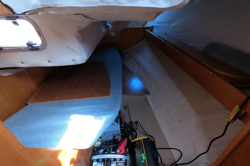 Slide: The Image of Interior cabin view of a 1990 Beneteau First 285 sailboat, featuring storage and electrical components. - 17