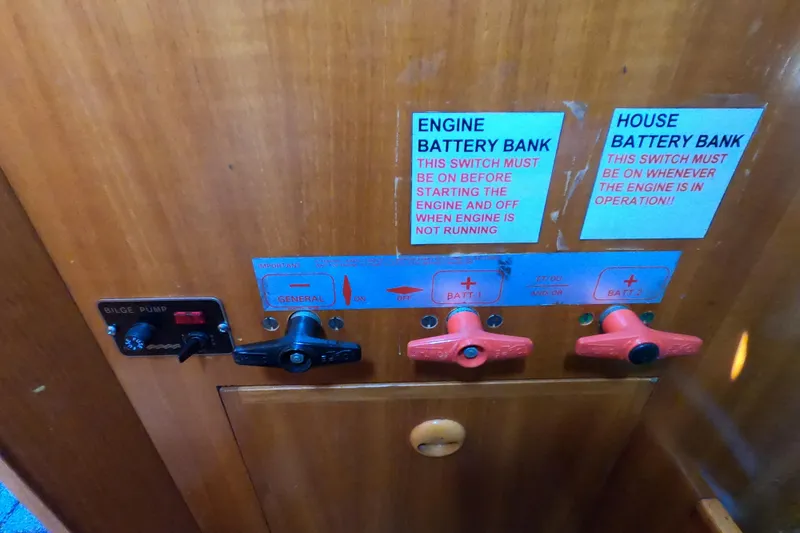 Slide: The Image of Control panel of a 1990 Beneteau First 285 sailboat with battery switches and bilge pump. - 19