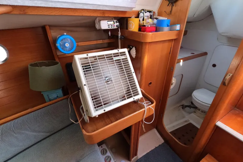 Slide: The Image of Interior of 1990 Beneteau First 285 sailboat with fan, lamp, and compact bathroom. - 24