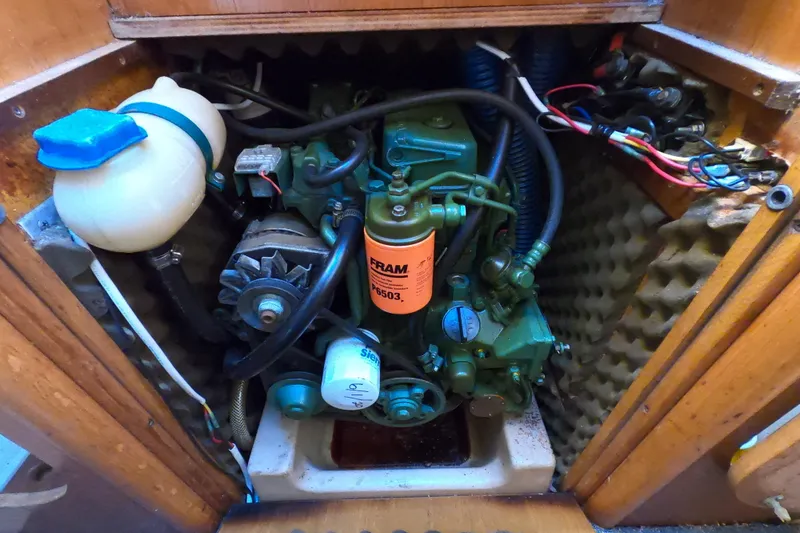 Slide: The Image of Engine compartment of a 1990 Beneteau First 285 sailboat, showcasing mechanical components. - 25