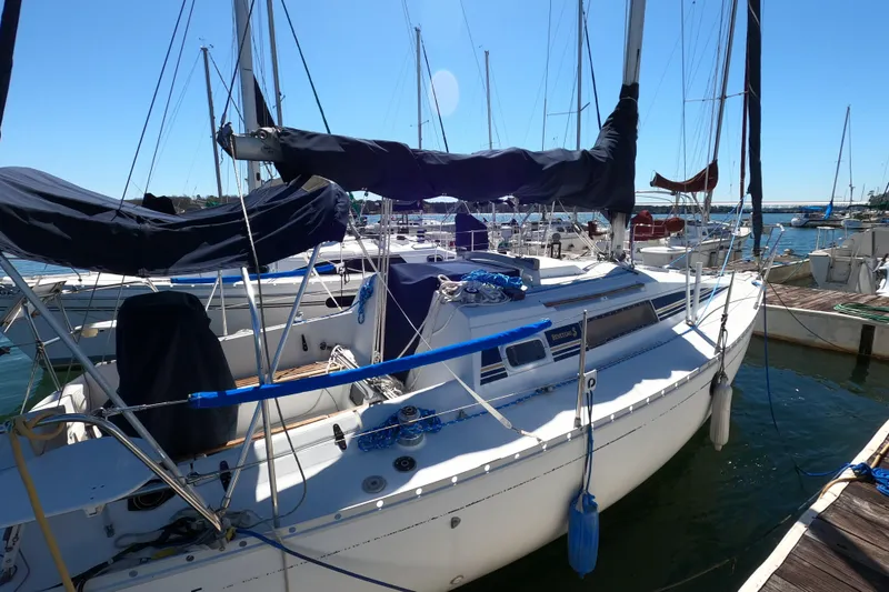Slide: The Image of 1990 Beneteau First 285 sailboat docked at marina on a sunny day. - 4