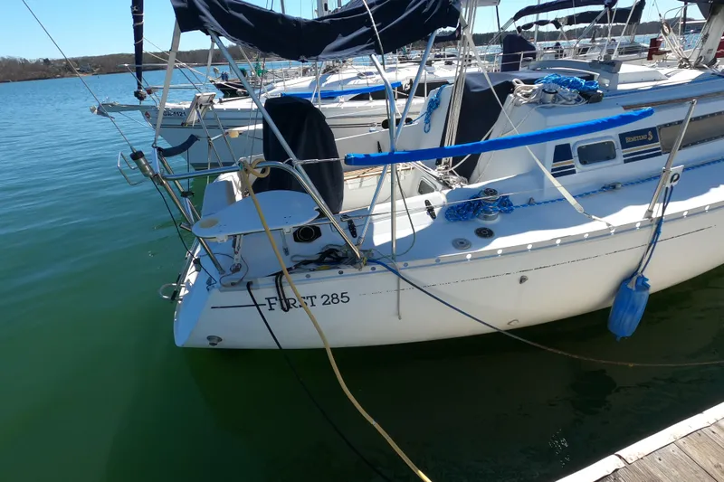 Slide: The Image of Sailboat Beneteau First 285, 1990 model, docked on calm water. - 5
