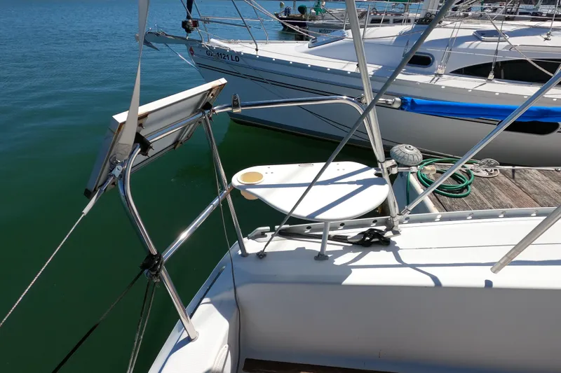 Slide: The Image of Beneteau First 285 sailboat, 1990 model, docked with visible deck and railing. - 9