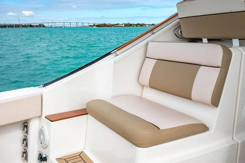 Slide: The Image of 2013 Tiara Yachts 3600 Coronet interior with beige seating, overlooking serene blue waters. - 14