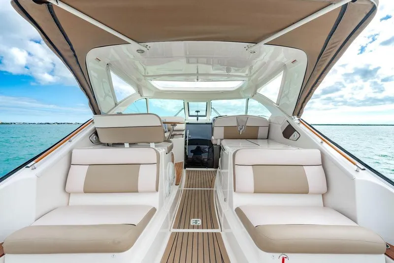Slide: The Image of 2013 Tiara Yachts 3600 Coronet interior with beige seating, open water view. - 16