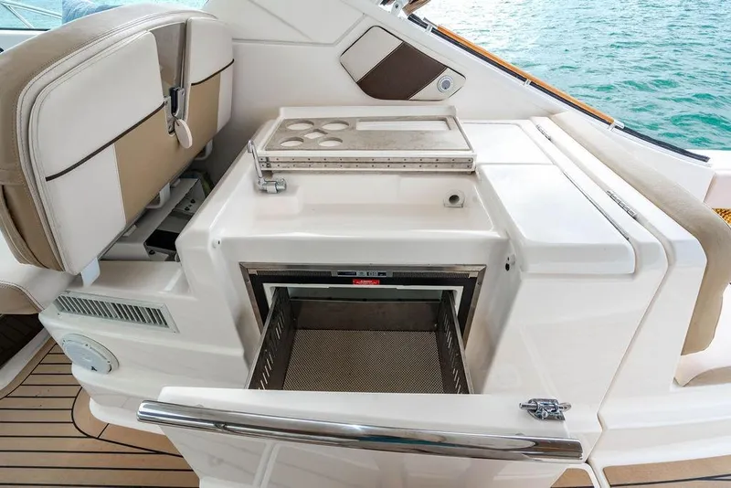 Slide: The Image of 2013 Tiara Yachts 3600 Coronet interior with seating and storage, overlooking the ocean. - 19