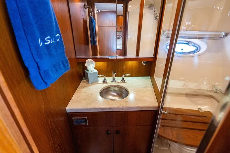 Slide: The Image of Luxurious bathroom interior of 2013 Tiara Yachts 3600 Coronet with wood accents and porthole. - 28
