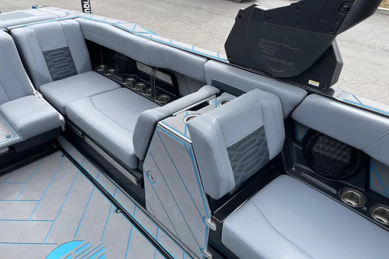 Slide: The Image of 2024 Malibu Wakesetter 26 LSV interior with gray seating and cup holders. - 10