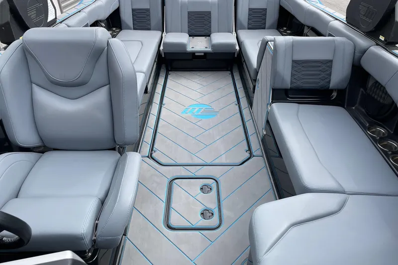 Slide: The Image of 2024 Malibu Wakesetter 26 LSV interior with luxurious gray seating and stylish flooring. - 13