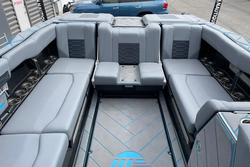 Slide: The Image of 2024 Malibu Wakesetter 26 LSV interior with luxurious gray seating and cup holders. - 9