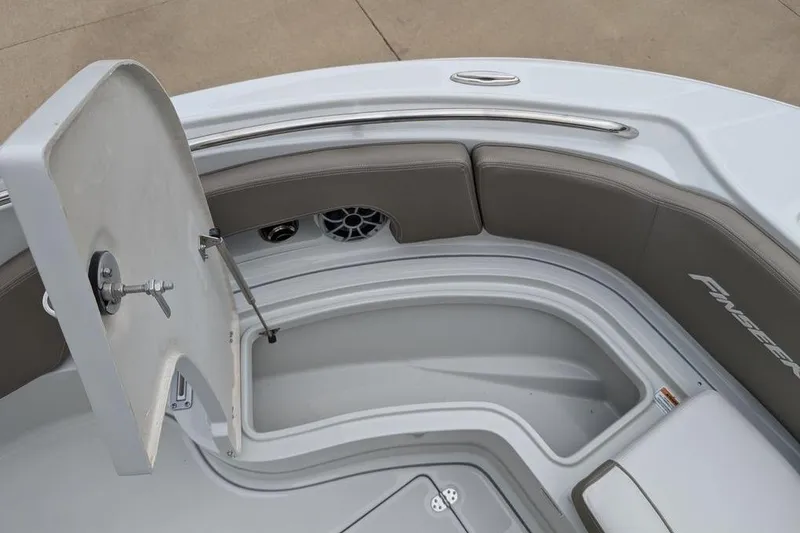 Slide: The Image of 2024 Finseeker 220 CC boat interior with open storage compartment and cushioned seating. - 14