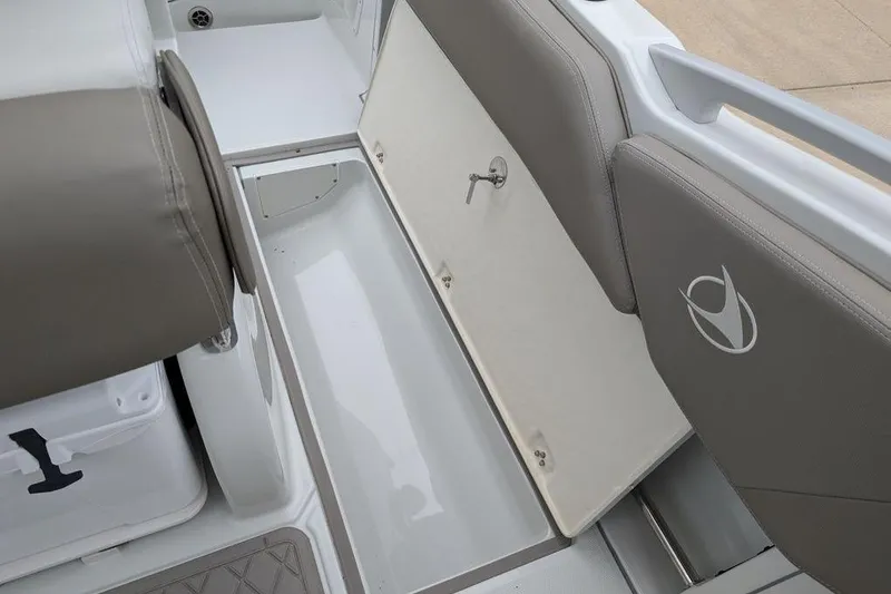 Slide: The Image of 2024 Finseeker 220 CC boat interior storage compartment with open hatch and seating. - 17