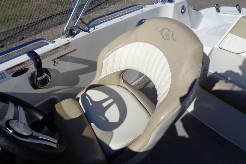 Slide: The Image of 2016 Stingray 192 SC boat interior with beige and white seating. - 12