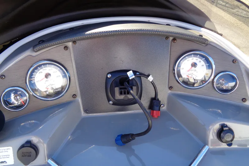 Slide: The Image of Dashboard of a 2016 Stingray 192 SC boat with gauges and connectors. - 14