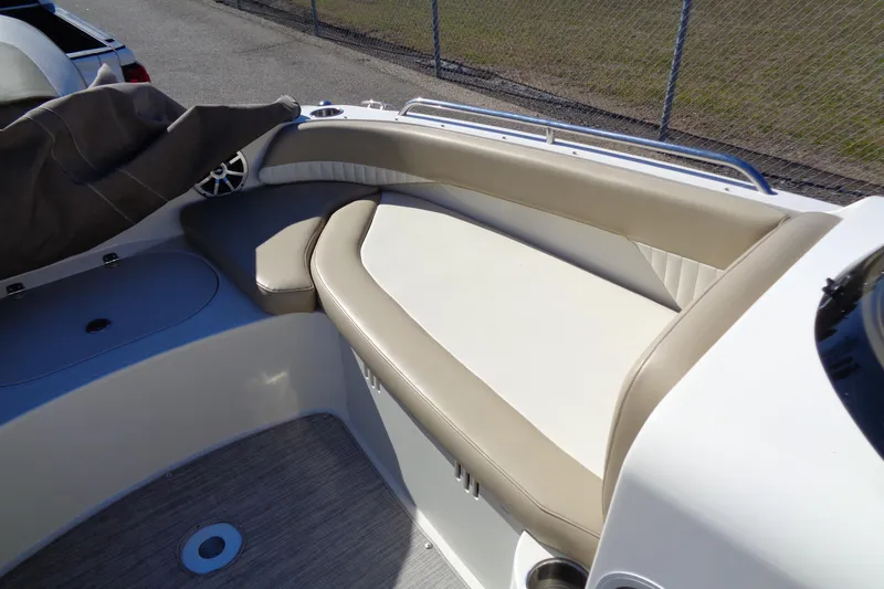 Slide: The Image of 2016 Stingray 192 SC boat interior with beige seating and speaker. - 17