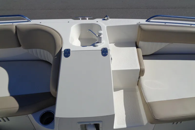 Slide: The Image of 2016 Stingray 192 SC boat interior with seating and sink area. - 19