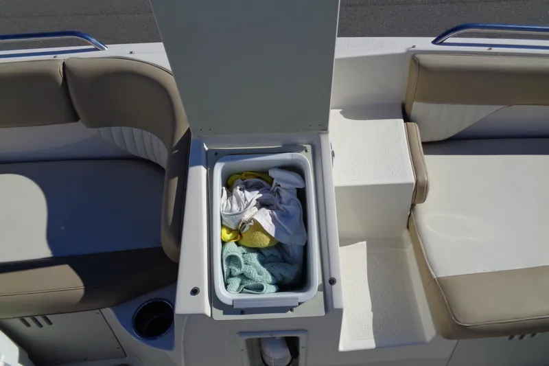 Slide: The Image of 2016 Stingray 192 SC boat interior with open storage compartment and seating. - 20
